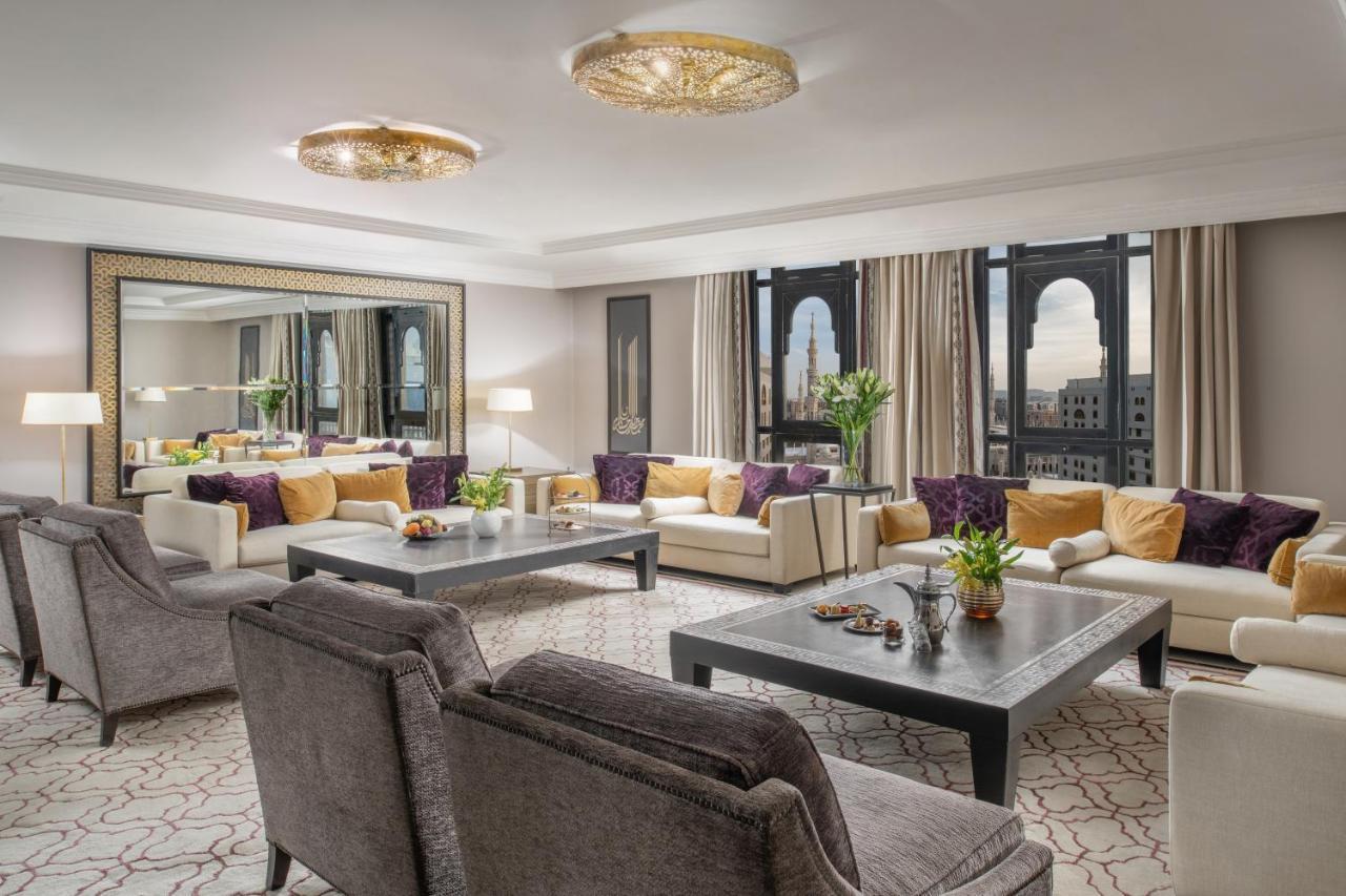 Sofitel Shahd Al Madinah Hotel Medina Exterior photo The photo shows a luxurious living room space. It features elegant furniture, including plush sofas with a mix of light and dark tones, and decorative cushions. A large coffee table sits in the center, adorned with a small plant and decorative items.